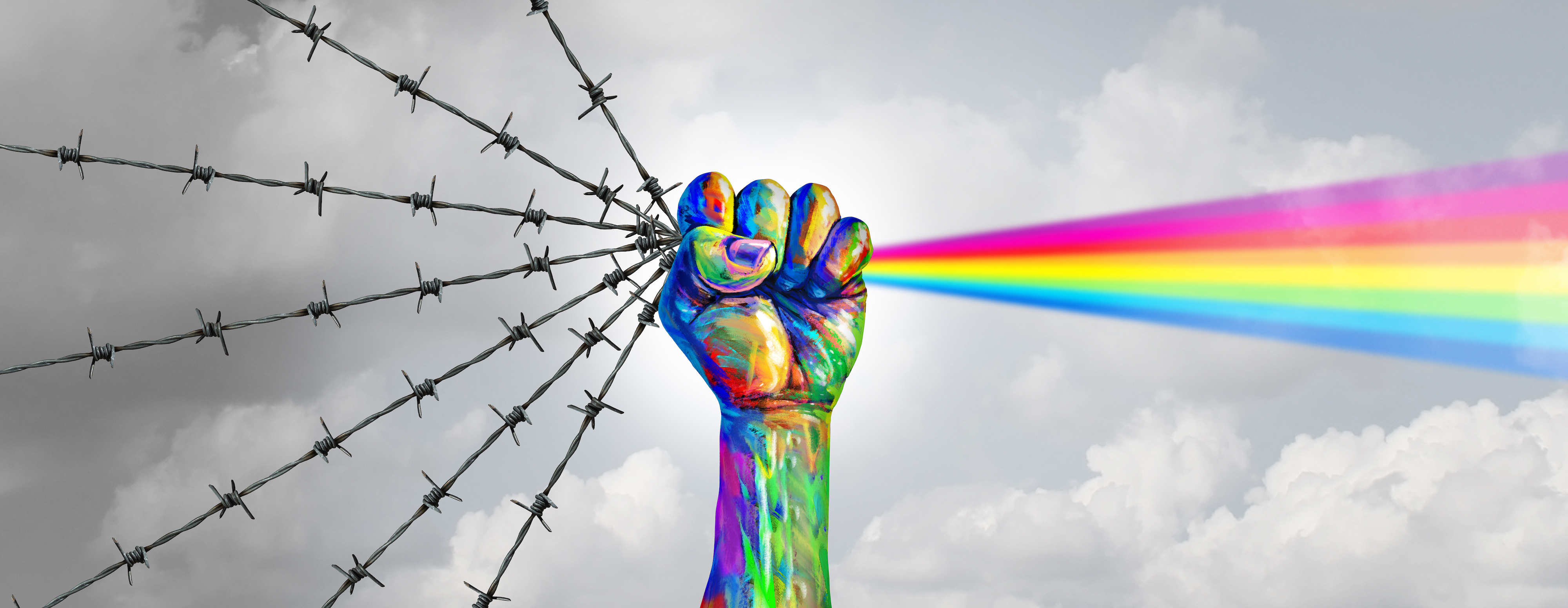 Hand holding barbed wire and a rainbow