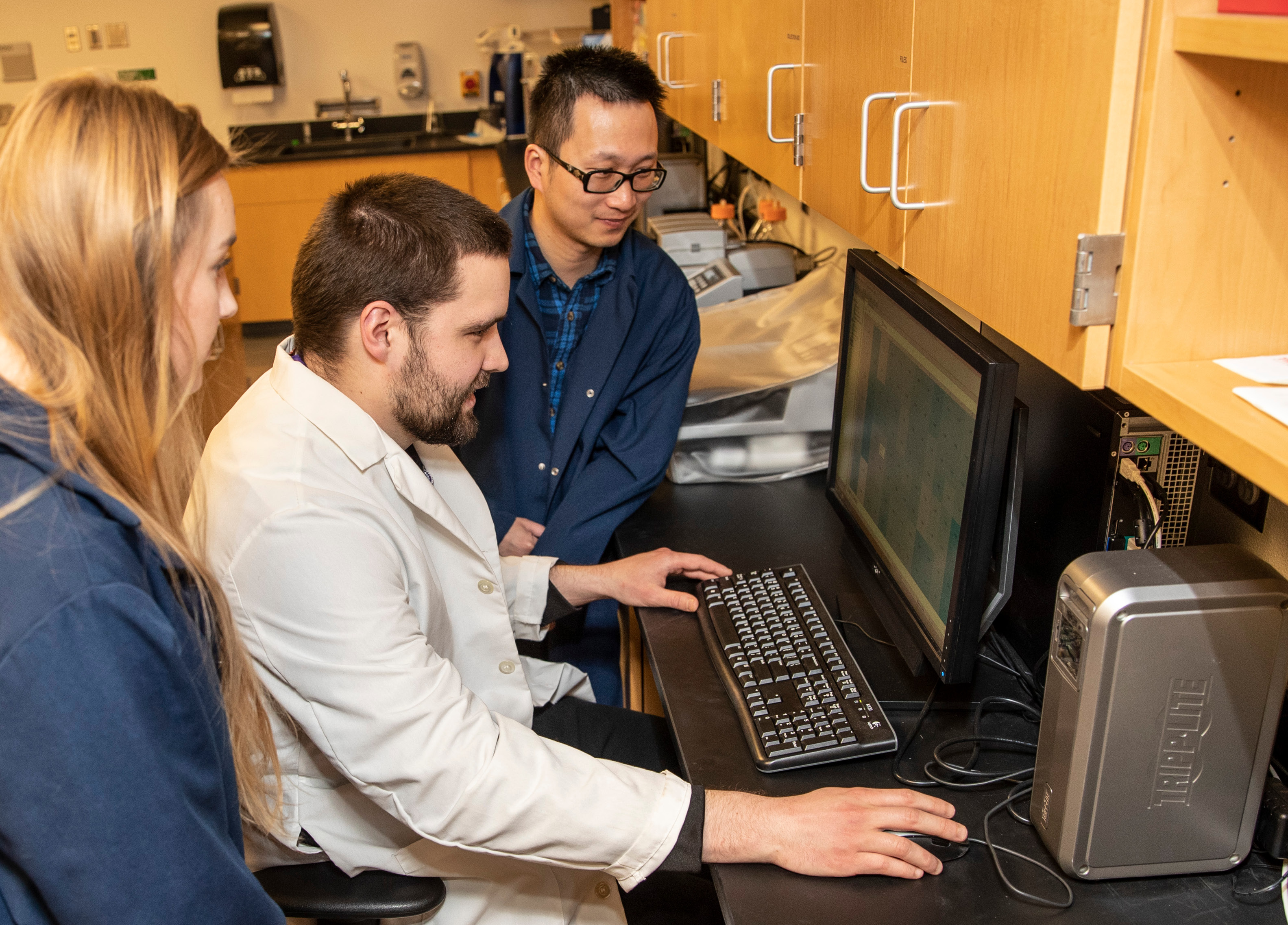 Psych professor with students in lab