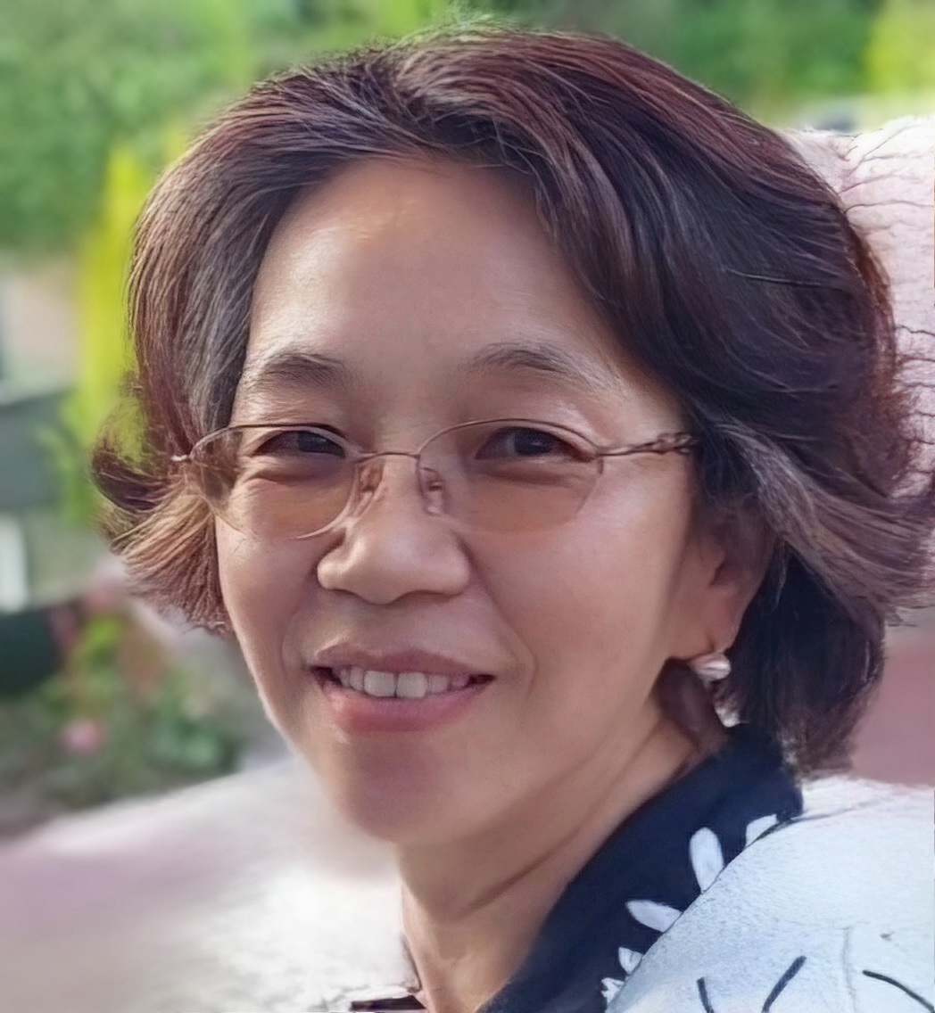 Korean woman with ear-length dark hair and glasses smiling at the camera.