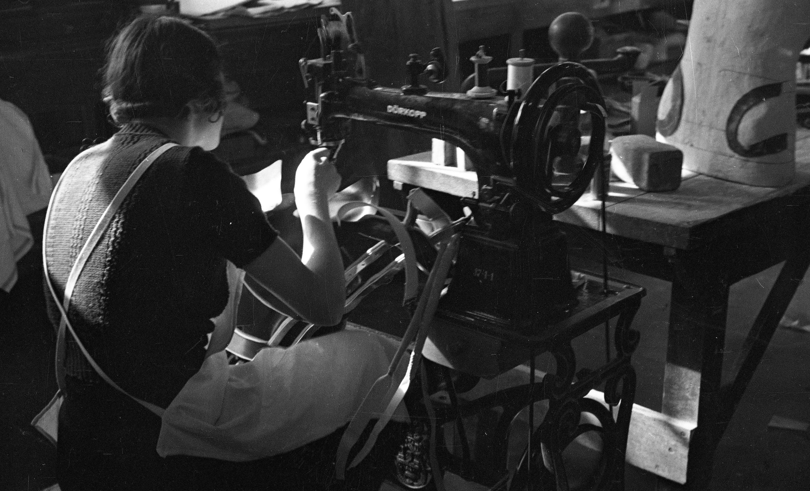 1930  A women working at a sewing machine. The original sleeve included "Nelson, Iowa."