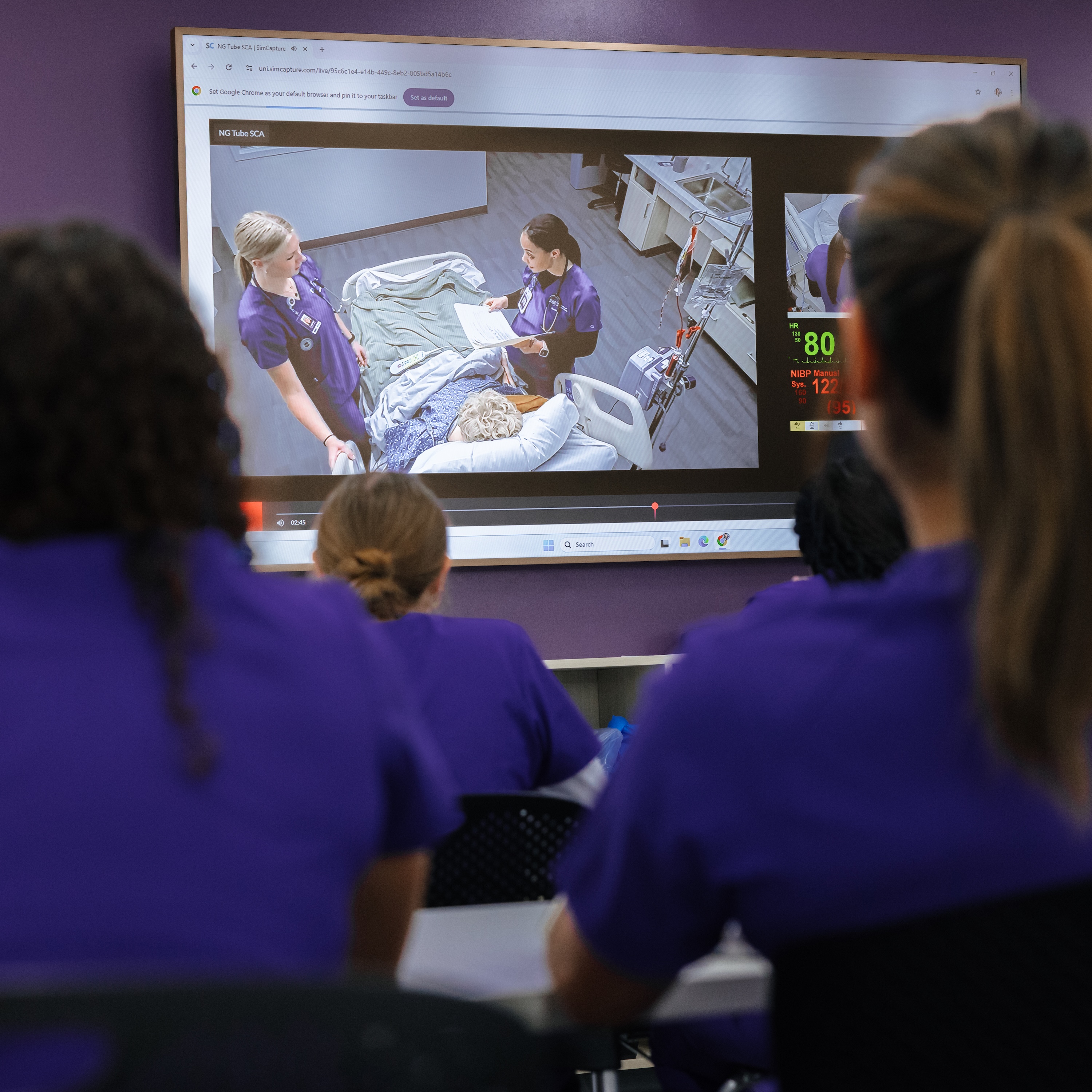 Nursing students watching live simulation
