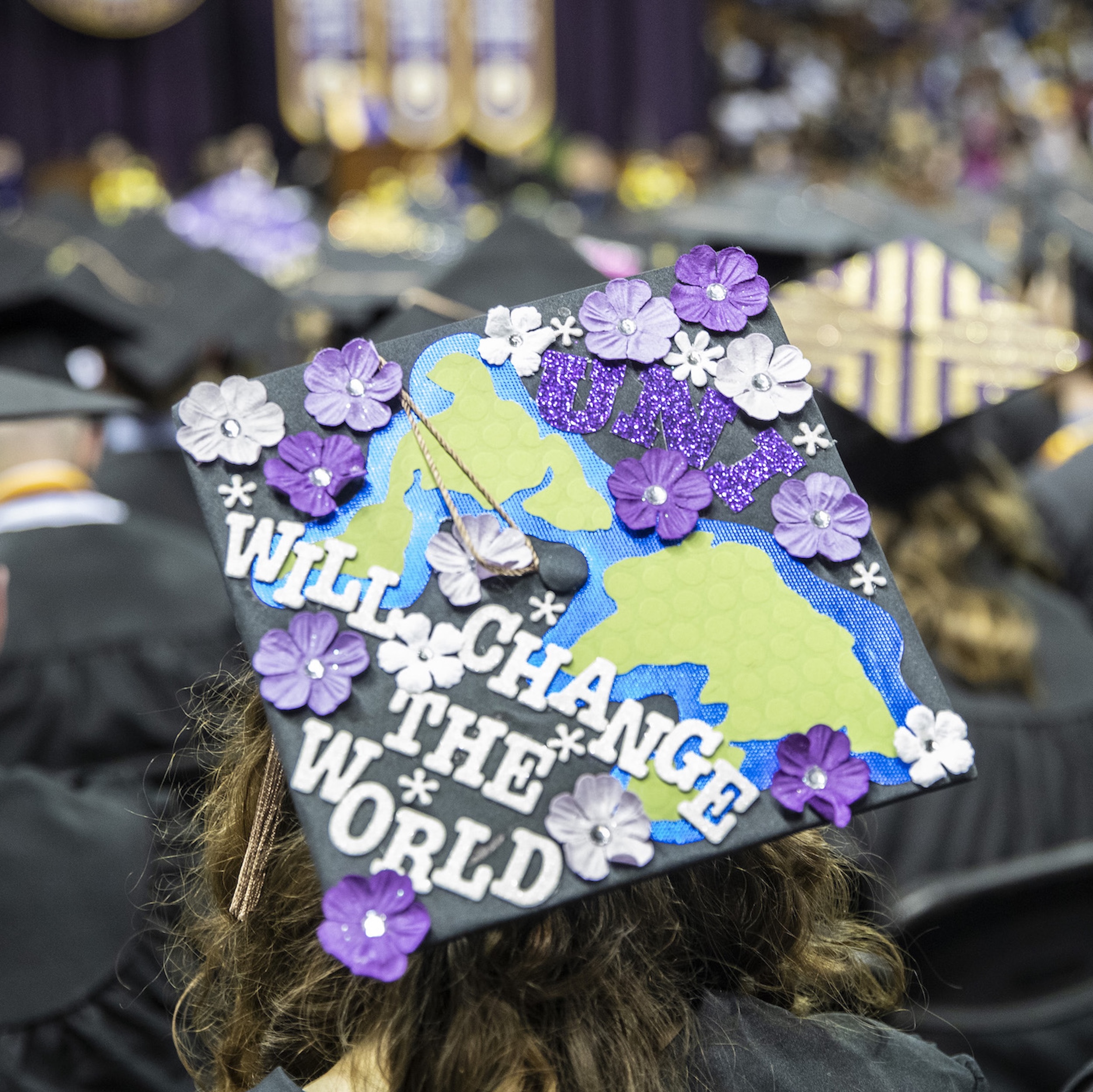 Graduation cap that says "UNI, will change the world"