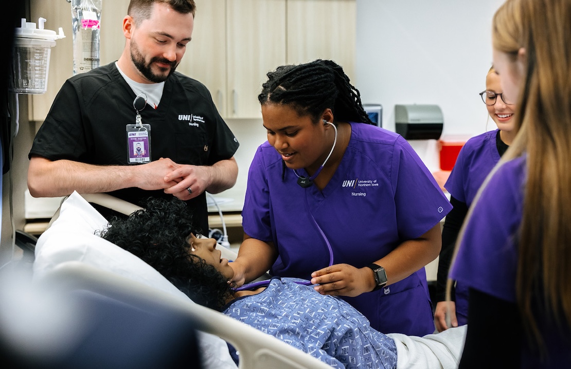 Nursing students with professor and manikins in simulation