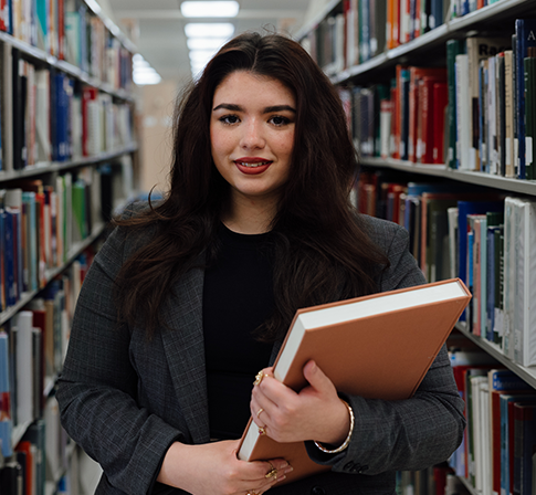 Person holding a book in the library