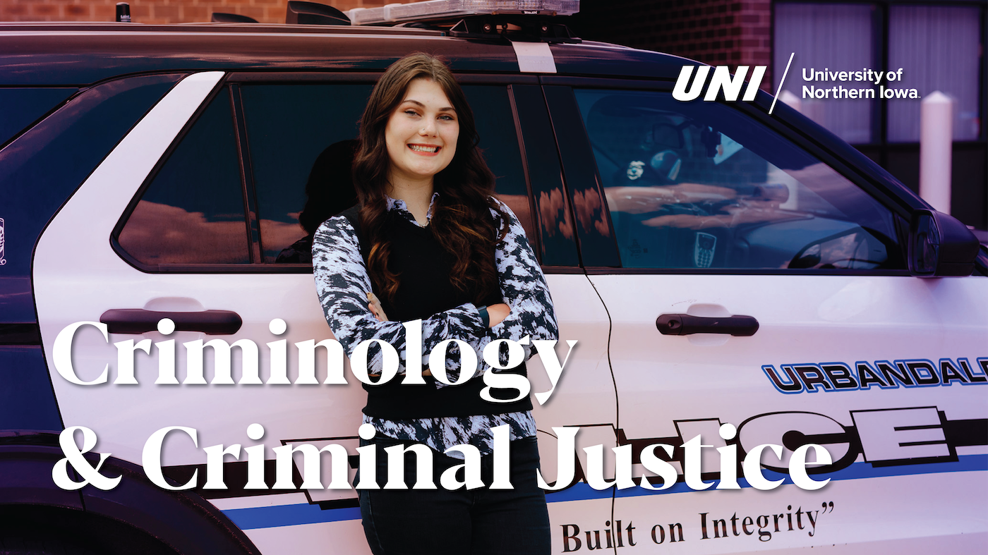 Criminology student in front of police car