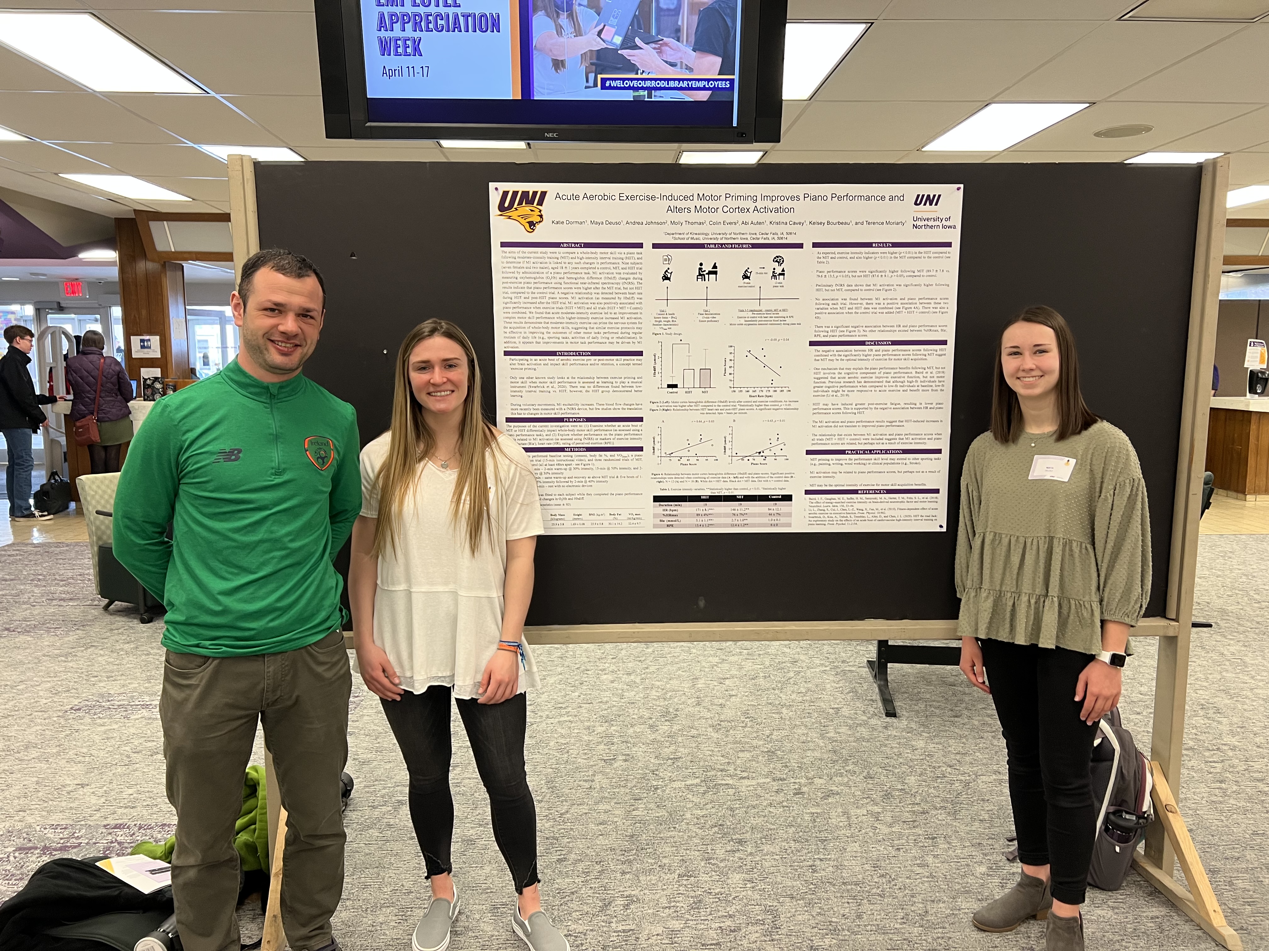 Pre-health students presenting research with professor.