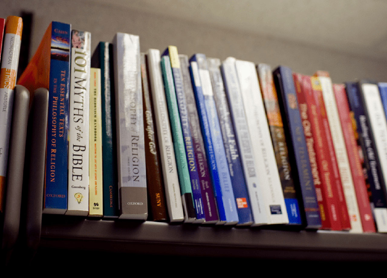 Religious books on a shelf.