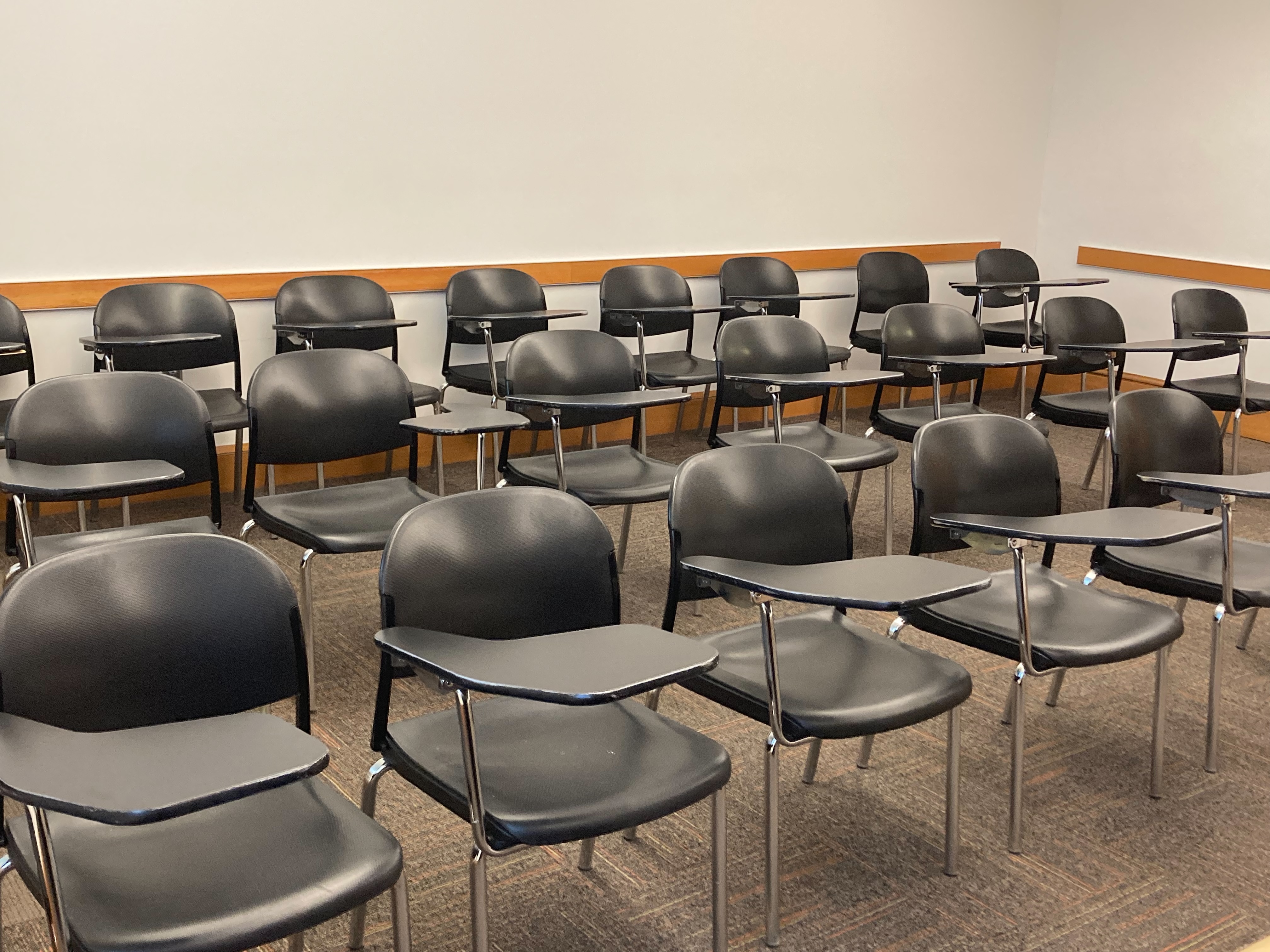 Classroom in Sabin Hall with three rows of arm desks.